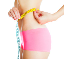 Weight loss concept. Woman measuring herself. Isolated on white.