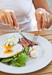 Traditional breakfast with bacon and fried eggs