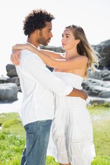 Naklejka premium Gorgeous couple embracing at the coast