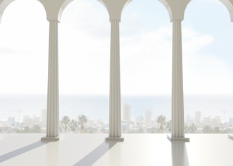 Room with pillars overlooking city and ocean