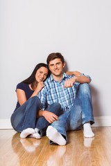 Young couple sitting on floor