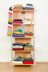 Fototapeta na wymiar Wardrobe with winter clothes nicely arranged on a shelf.