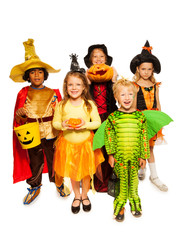 Kids with pumpkin and in Halloween costumes