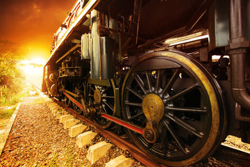 Naklejka premium iron wheels of stream engine locomotive train on railways track
