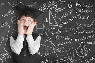 boy near blackboard with formulas