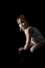 little girl sitting on a chair