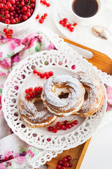 Cream puff rings decorated with fresh red currant
