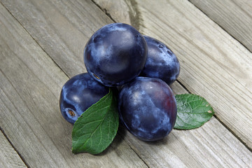 fresh plums on wooden background
