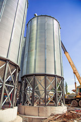 Background, metal barrels granaries on the sky background