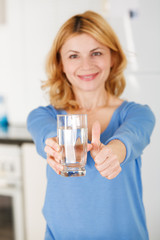 Beautiful woman holding a glass of water