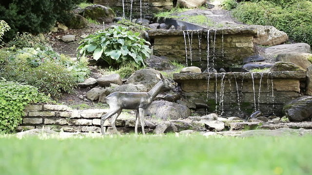 Artificial waterfall with baby deer