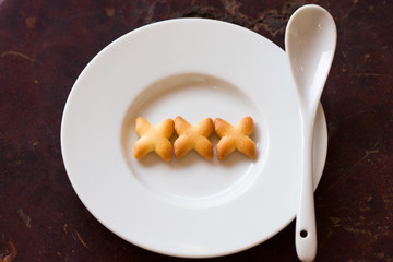 Sweet cookies on white plate, Sex on plate