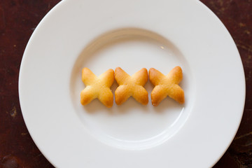 Sweet cookies on white plate, Sex on plate