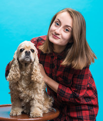 Pretty smiling girl with american spaniel