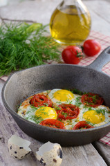 Breakfast with fried quail eggs with cherry tomatoes