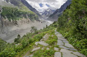 Fototapeta na wymiar Alpine landscape with path, mountains and glacier