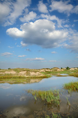 Fototapeta na wymiar Marsh after sand excavation, landscape with beautiful sky
