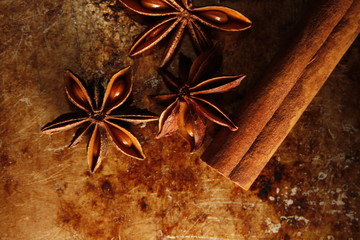 close up of star anise and cinnamon on old vintage metal desk
