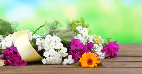 Flower wreath on wooden background