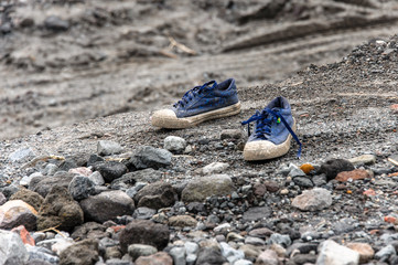 A pair of old sneakers on the edge of the coulee after eruption