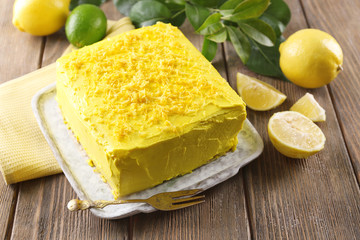 Tasty lemon cake on wooden table