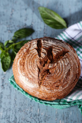 Fresh baked bread and fresh basil, on wooden background