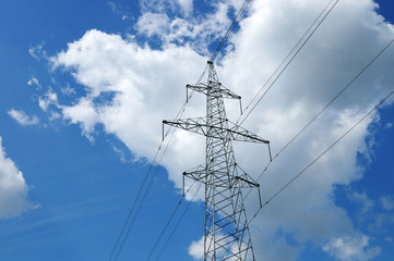 High-voltage electrical cables pylon against a blue sky