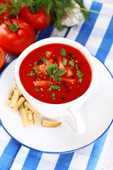 Tasty tomato soup with croutons on table close-up