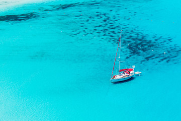 Fototapeta premium Sailboat anchored in Porto Giunco bay. Sardinia Island. Italy.
