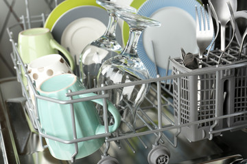Open dishwasher with clean utensils in it