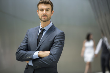Portrait of attractive single man with couple in the back