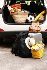 Suitcases and bags in trunk of car ready to depart for holidays