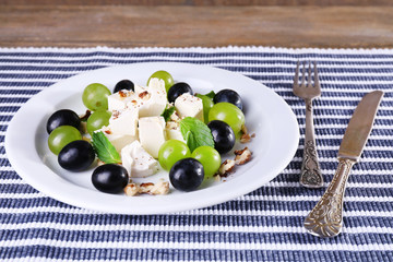 tasty salad with grape and cheese, close up