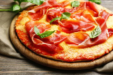 Delicious pizza served on wooden table