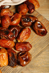 Tasty dates fruits on wooden table