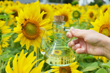Bottle of oil against sunflowers