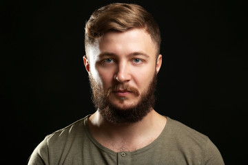 Obraz premium Portrait of handsome man with beard on black background