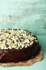 Tasty chocolate cake with almond, on old wooden table