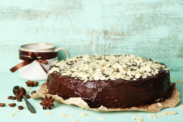 Tasty chocolate cake with almond, on old wooden table