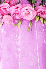 Beautiful eustoma flowers on wooden background