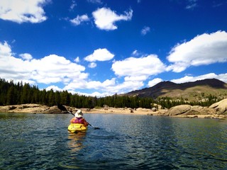 Woman kayaking on beautiful Mountain Lake.