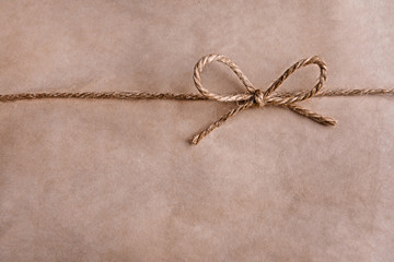 Paper texture with rope bow, close-up