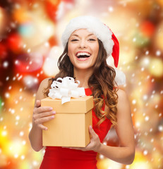 smiling woman in santa helper hat with gift box