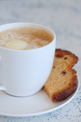 Cup of latte coffee with cake