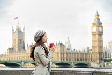 Fototapeta na wymiar London woman drinking coffee by Westminster Bridge