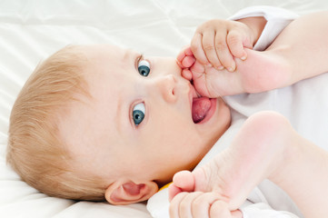 happy baby playing with his feet