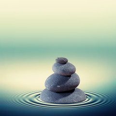 Obraz na płótnie Canvas Wet pebble in the water , alternative medicine concept