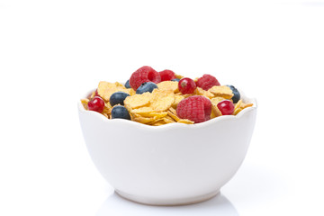 bowl of cornflakes with fresh seasonal berries, isolated