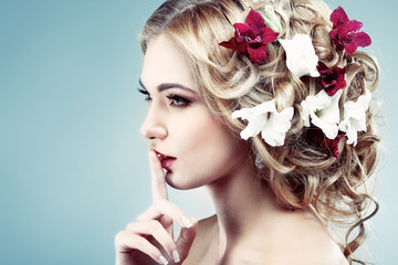 Beautiful girl with varicoloured flowers in hairs