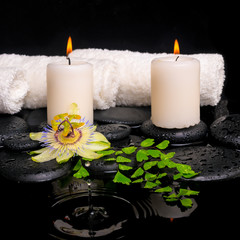 Obraz na płótnie Canvas spa setting of passiflora flower, green branch fern and candles